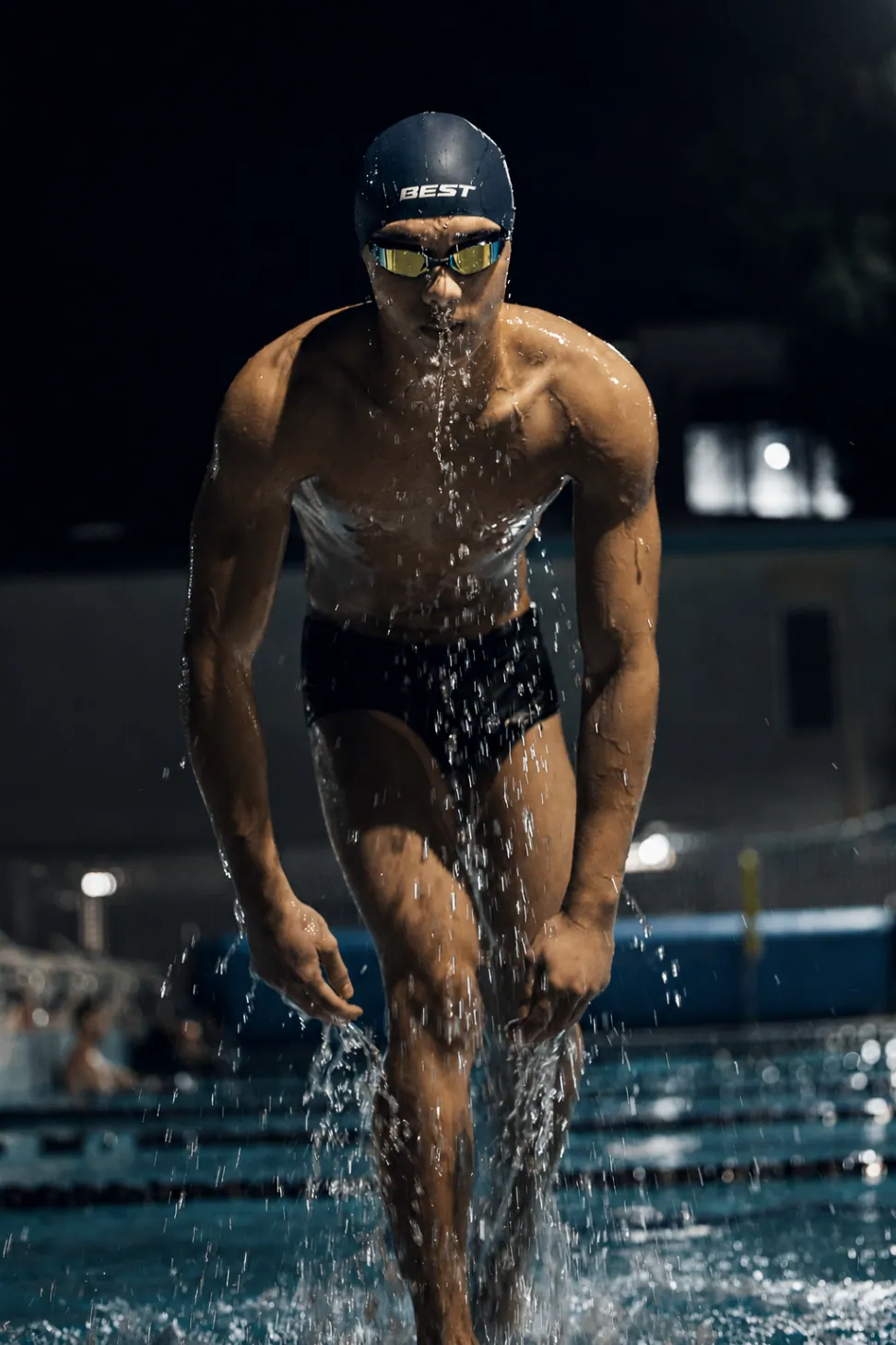 BEST swimmer emerging from the water in a performance cap